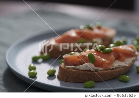 Bruschettas with cream cheese and salmon on dining table 96635629