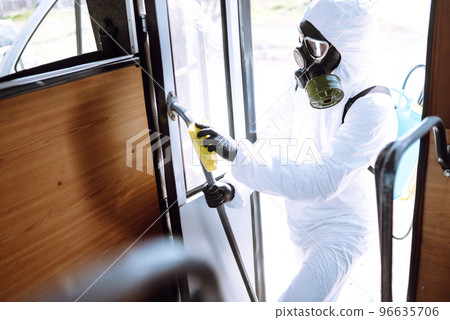Cleaning and Disinfection transport. Man in protective suit washing , disinfection public transport 96635706