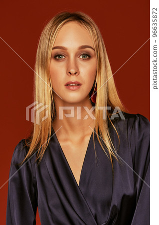 Seductive close up portrait of beautiful blonde young woman in cocktail dress 96635872