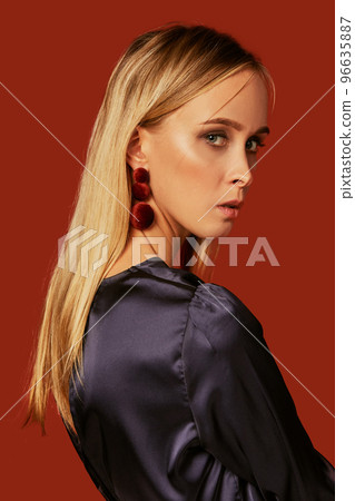 Seductive close up portrait of beautiful blonde young woman in cocktail dress. Side view 96635887