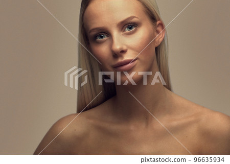 Portrait of a smiling beautiful woman with blonde hair in studio 96635934