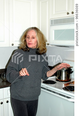 Female beauty cooking dinner indoors. 96636089