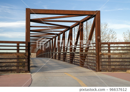 footbridge and bike trail over a river 96637612