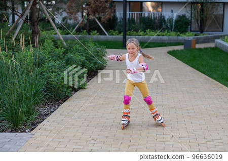 A little girl and her mom do a bridge exercise at the outdoor sports ground.  96638019