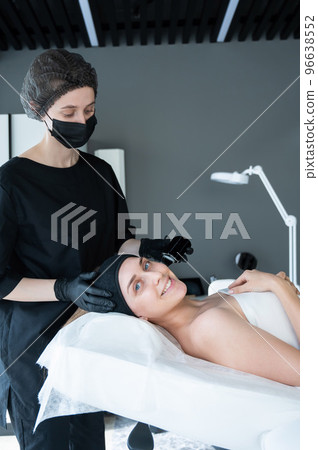 Woman on ultrasonic cleaning procedure. Hardware cosmetology. Woman on ultrasonic cleaning procedure. Hardware cosmetology. 96638552