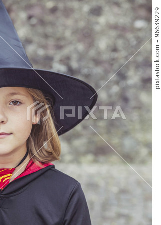young fair-haired sorceress in mantle and hat 96639229