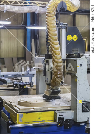 CNC machine cuts a round piece at the factory 96639291