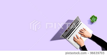 Person using a laptop computer Person using a laptop computer 96639703