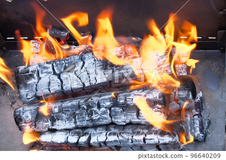 Flames, burning woods and smoke close up. Grilling season in nature open. Flames, burning woods and smoke close up. Grilling season in nature open. 96640209