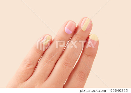 Fashionable minimal spring summer nail design. Beautiful yellow lavender manicure on begie background 96640225