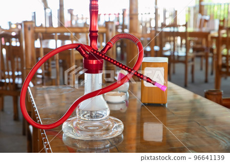 Shisha hookah with red hot coals stands on a table Shisha hookah with red hot coals stands on a table 96641139