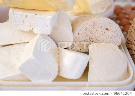 Homemade Caucasian cheese or Bryndza cut in slices at local market Homemade Caucasian cheese or Bryndza cut in slices at local market 96641204