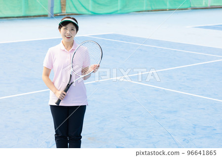 A woman enjoying tennis A woman enjoying tennis 96641865