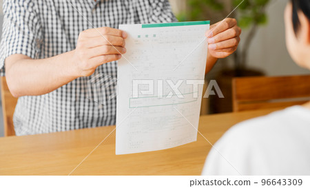 A middle-aged man presenting a divorce notice to a middle-aged woman Image of a middle-aged divorce A middle-aged man presenting a divorce notice to a middle-aged woman Image of a middle-aged divorce 96643309