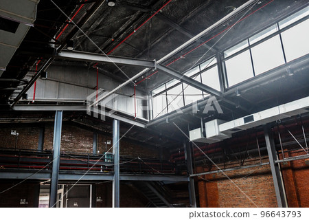 Unmanned, industrial-style old warehouse building space. 96643793