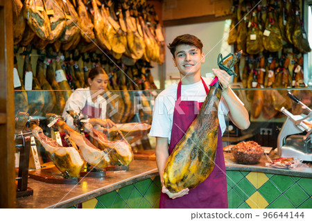 Owner of butcher shop selling traditional spanish jamon Owner of butcher shop selling traditional spanish jamon 96644144