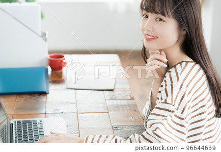 Portrait of a woman operating a computer Portrait of a woman operating a computer 96644639