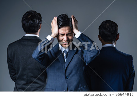 Young businessman troubled between bosses 96644915