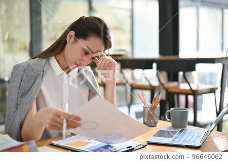 Stressed and serious Asian businesswoman examining report, worried about her project's deadline Stressed and serious Asian businesswoman examining report, worried about her project's deadline 96646062