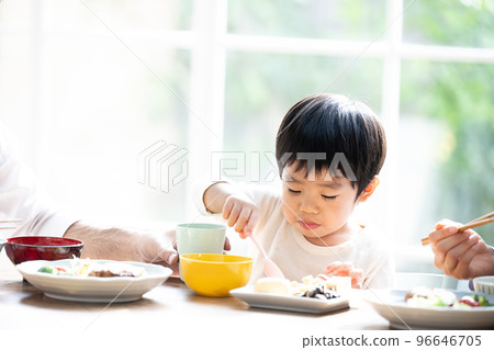 Close-up of a cute toddler eating rice hard 96646705
