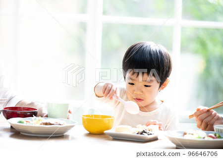 Close-up of a cute toddler eating rice hard 96646706