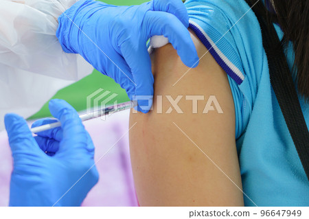 Nurse holding a syringe for the injection giving patient vaccine in hospital. Health care Concept 96647949