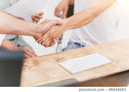 close up. background image of friendly handshake of employees . close up. background image of friendly handshake of employees . 96648063