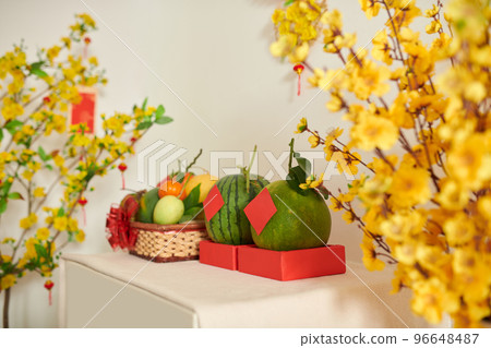 Fresh fruits and blooming apricot branches for Tet celebration 96648487