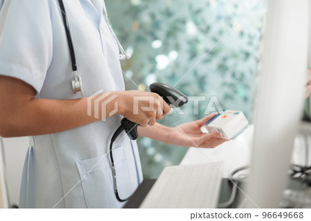 Medicine and health concept, Female pharmacist scanning medicine product barcode in cash register 96649668