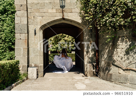 a beautiful woman in a white dress walks through a beautiful palace on a sunny day a beautiful woman in a white dress walks through a beautiful palace on a sunny day 96651910