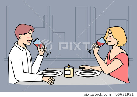 Man, woman sit at table, drink red wine in restaurant. Man, woman sit at table, drink red wine in restaurant. 96651951