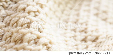 closeup beige knitted woolen fabric texture background closeup beige knitted woolen fabric texture background 96652714
