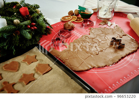 raw rolled dough for ginger cookies with cutter in shape of man. Traditional sweets for winter holidays 96653220
