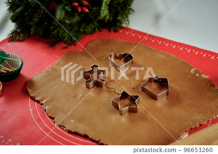 Raw rolled dough for ginger cookies with cutter. Traditional sweets for winter holidays 96653260