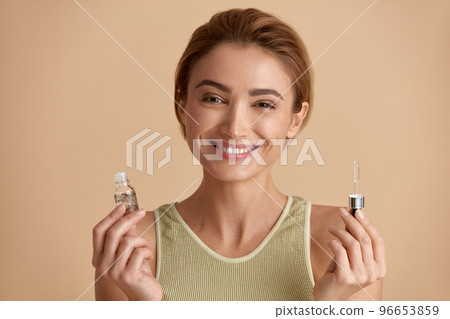 Woman Posing With Serum. Woman Holding Essential Oil For Facial Skin 96653859