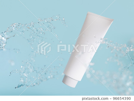 White and blank, unbranded cosmetic cream tube with water splash. Skin care product presentation on blue background. Modern mock up. Tube with copy space. 3D rendering. 96654390