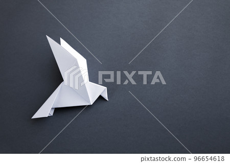 White paper dove origami isolated on a grey background 96654618