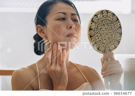 Middle woman skin care/worried image 96654677