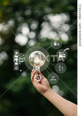 Hand holding anti nature light bulb on green leaf with renewable and sustainable development energy source icon. for renewable,love the world 96654811