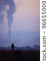 silhouette of a man standing watching a coal power plant There are high chimneys that emit smoke from the combustion energy of the transfer stone, concept environmental destruction global warming. 96655009