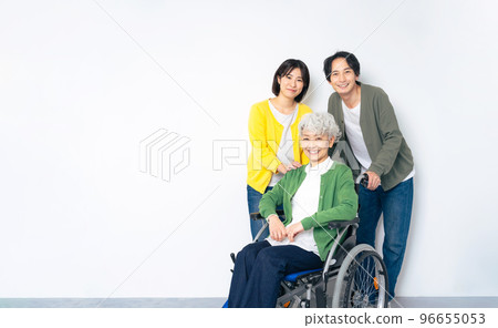 Senior woman in wheelchair and family portrait 96655053