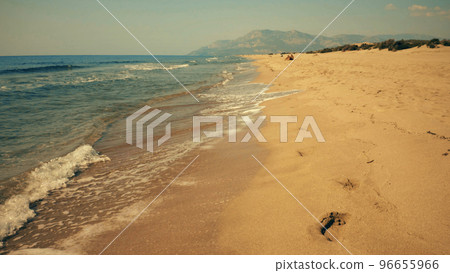 Sea waves washing sandy beach. Slow motion. Aerial view of coastal resort. Sea waves washing sandy beach. Slow motion. Aerial view of coastal resort. 96655966