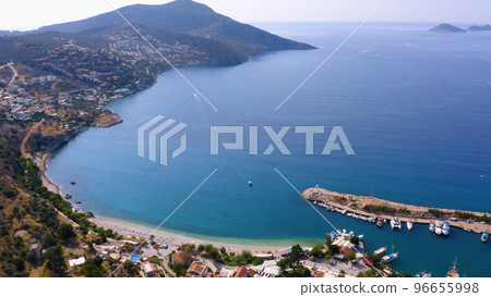 Aerial drone view of coastal town with green mountains. Turquoise sea bay with boats anchored at harbor. Antalya province, Turkey. Aerial drone view of coastal town with green mountains. Turquoise sea bay with boats anchored at harbor. Antalya province, Turkey. 96655998