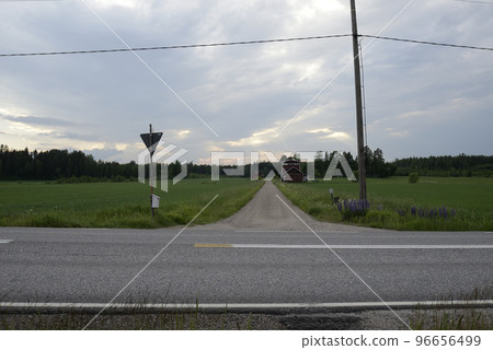crossroads of dirt and asphalt roads somewhere in Finland crossroads of dirt and asphalt roads somewhere in Finland 96656499