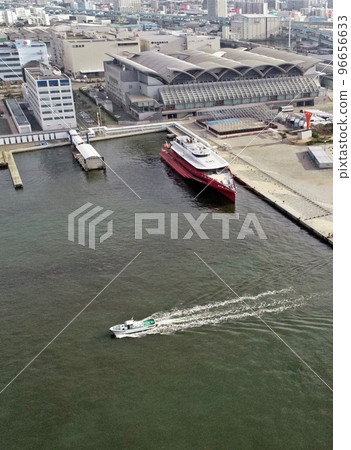A fishing boat sailing with Marine Messe in the background 96656633