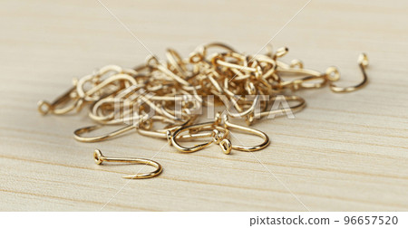 Close up, Pile of fish hooks on wooden background Close up, Pile of fish hooks on wooden background 96657520