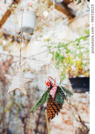 Pine cone DYI natural Christmas decoration hanging outdoor. Environment, recycle, reuse and zero waste concept. Selective focus, focus space Pine cone DYI natural Christmas decoration hanging outdoor. Environment, recycle, reuse and zero waste concept. Selective focus, focus space 96658029