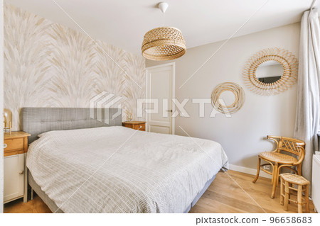Home interior design of bedroom with bed and wooden wardrobe placed in corner near window in modern apartment Home interior design of bedroom with bed and wooden wardrobe placed in corner near window in modern apartment 96658683