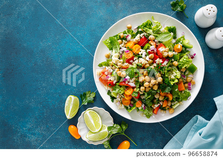 Tabbouleh salad. Tabouli salad with fresh parsley, onions, tomatoes, bulgur and chickpea. Healthy vegetarian food, diet. Top view Tabbouleh salad. Tabouli salad with fresh parsley, onions, tomatoes, bulgur and chickpea. Healthy vegetarian food, diet. Top view 96658874