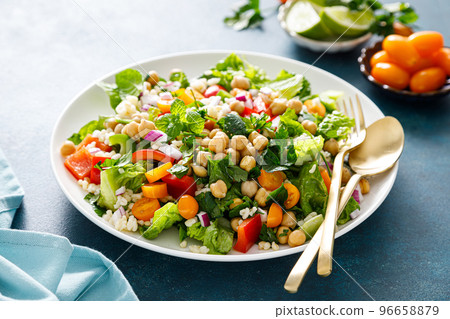 Tabbouleh salad. Tabouli salad with fresh parsley, onions, tomatoes, bulgur and chickpea. Healthy vegetarian food, diet Tabbouleh salad. Tabouli salad with fresh parsley, onions, tomatoes, bulgur and chickpea. Healthy vegetarian food, diet 96658879